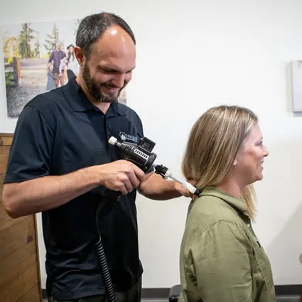 Chiropractor providing neck therapy treatment for a patient at Trailhead Family Chiropractic in Murrieta, CA