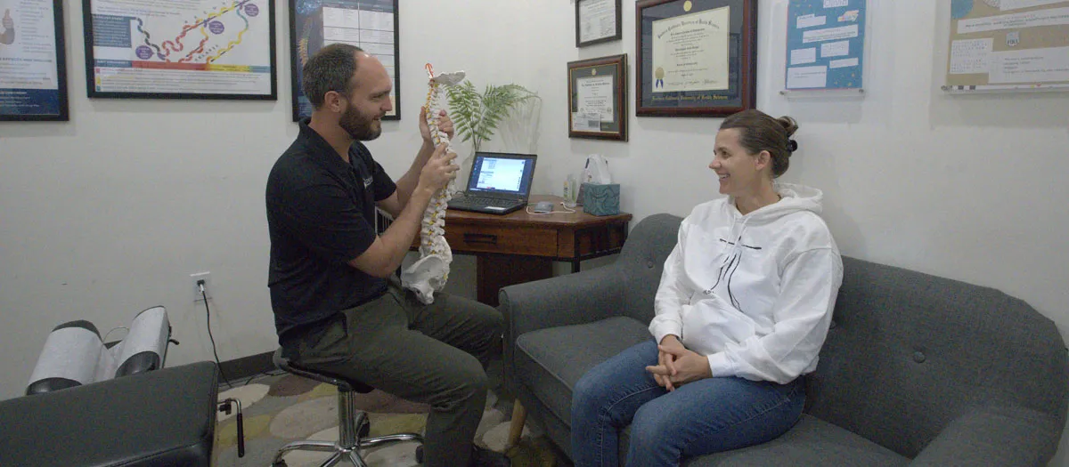 Chiropractor explaining spinal health to a patient during a consultation at Trailhead Family Chiropractic in Murrieta, CA
