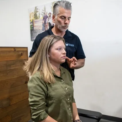 Chiropractor performing a posture and spinal assessment for a patient at Trailhead Family Chiropractic in Murrieta, CA