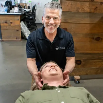 Chiropractor providing a gentle neck adjustment for a patient at Trailhead Family Chiropractic in Murrieta, CA