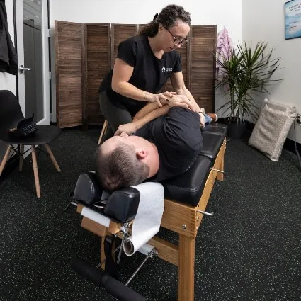Chiropractor performing a side-lying adjustment on a patient at Trailhead Family Chiropractic in Murrieta, CA