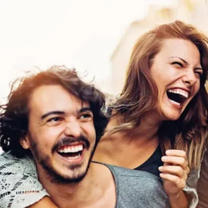 Smiling couple laughing together, representing healthy living, connection, and whole-body wellness supported by chiropractic care
