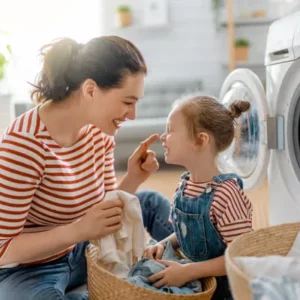 Mother and daughter smiling together at home, representing family wellness and healthy daily living supported by chiropractic care