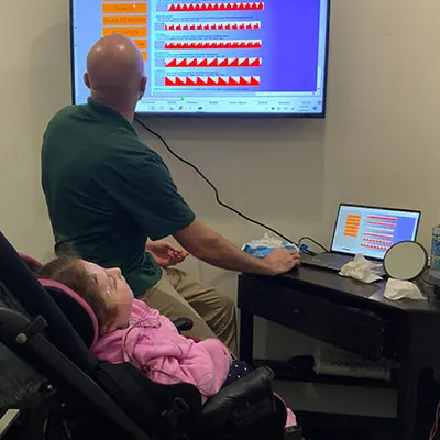 Chiropractor reviewing assessment results with a child patient at Trailhead Family Chiropractic in Murrieta, CA