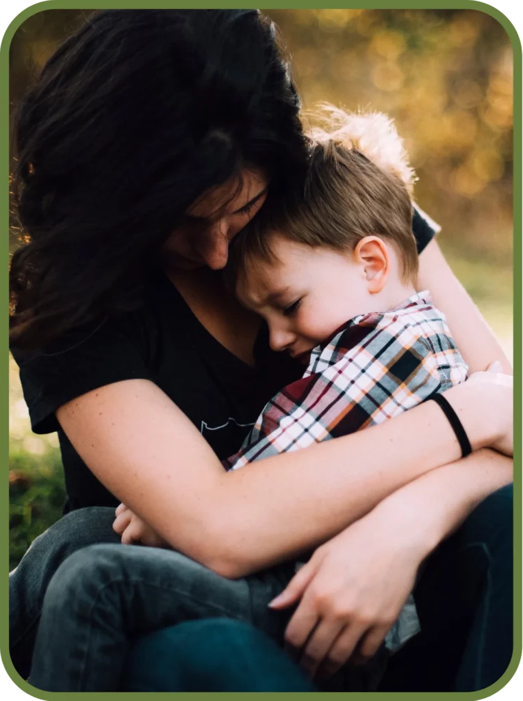 Mother holding her child close, representing family comfort, emotional wellness, and supportive care at Trailhead Family Chiropractic