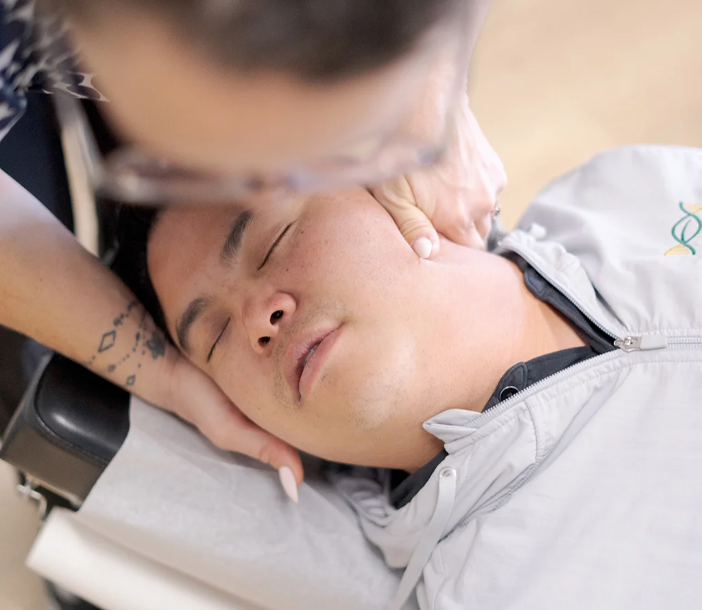 Chiropractor providing gentle neck care for a patient at Trailhead Family Chiropractic