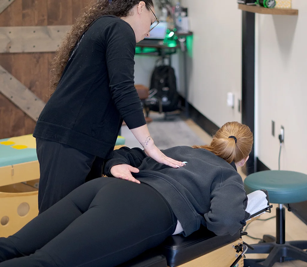 Chiropractor performing a prone back adjustment for a patient in Temecula