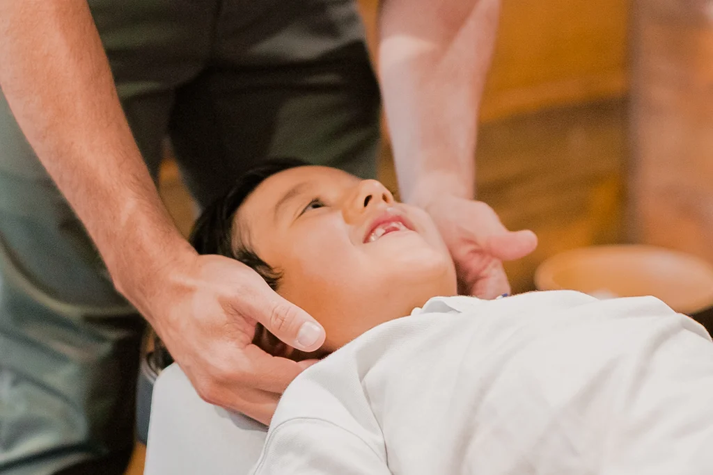 Pediatric chiropractor providing gentle neck care for a child in Temecula
